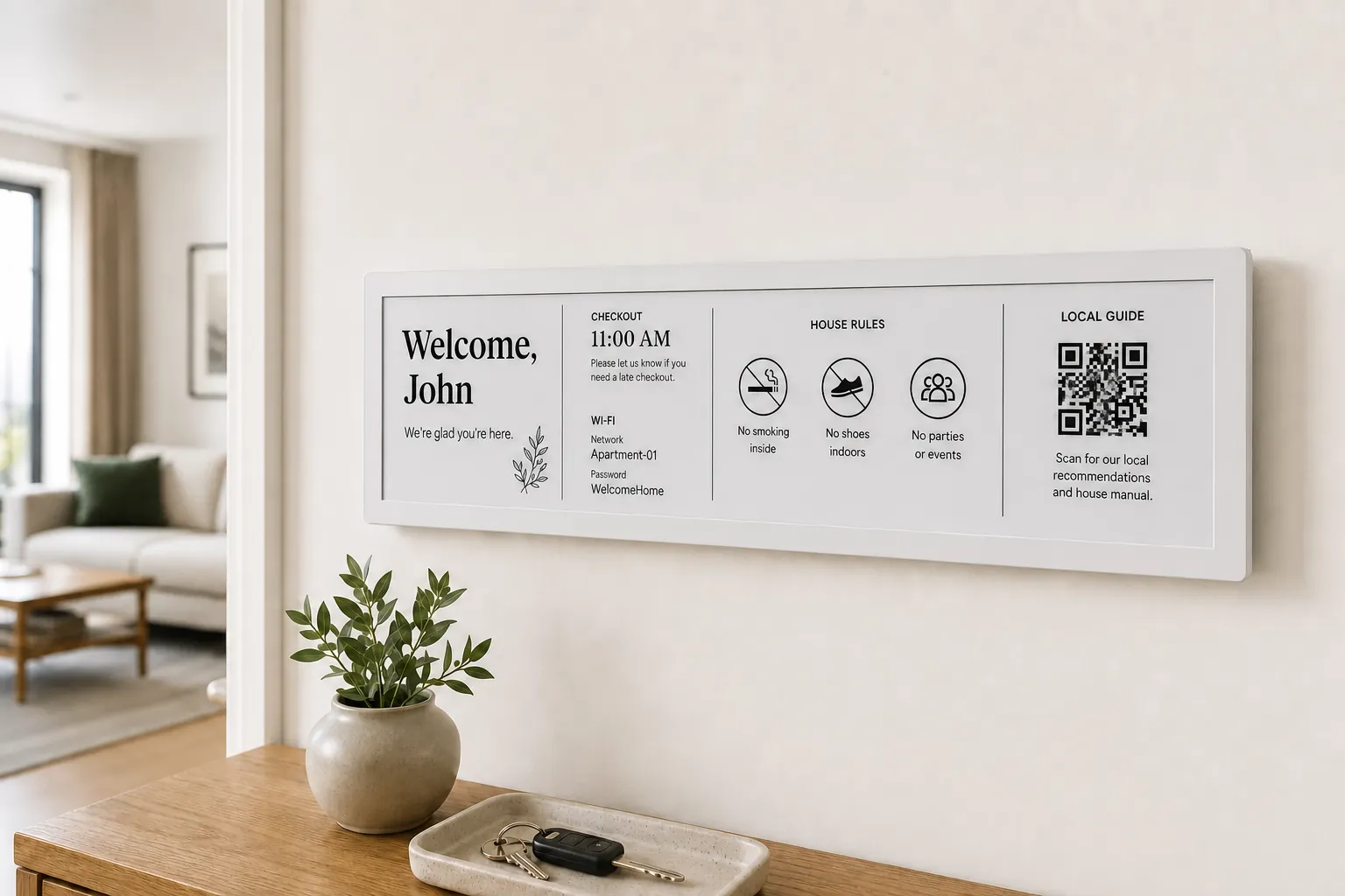 Wide InnSlate e-ink guest display welcoming John near the entrance of a serviced apartment